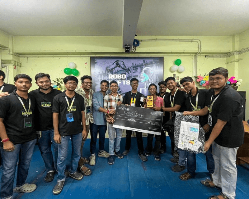 LNC robotics team celebrating with trophies and an award cheque