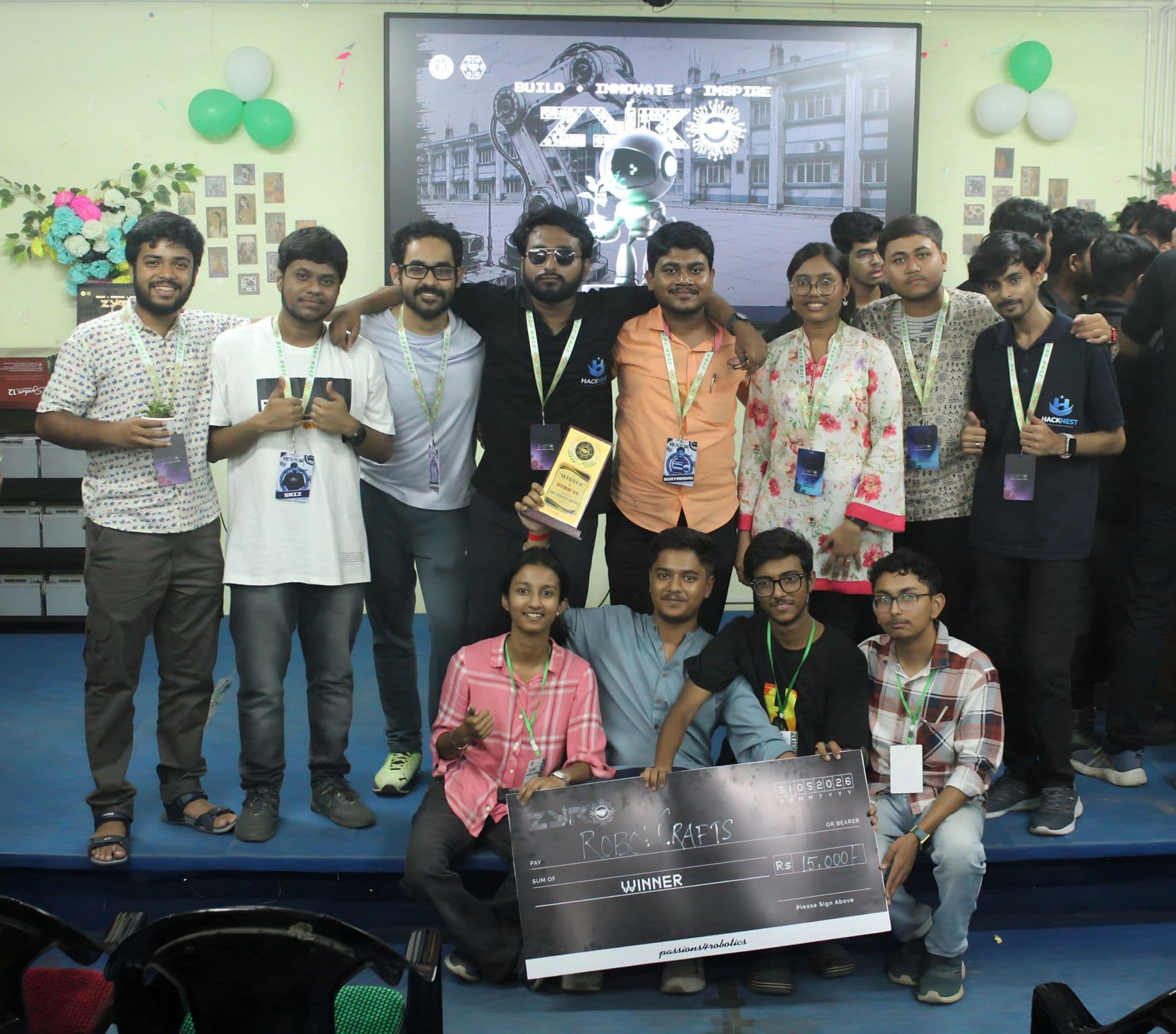 Hackathon winners gathered with trophies and an award cheque
