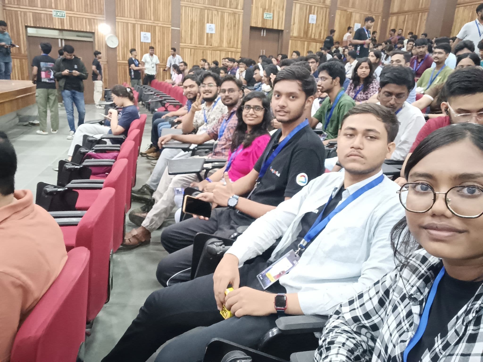 Community members taking a selfie in a conference auditorium