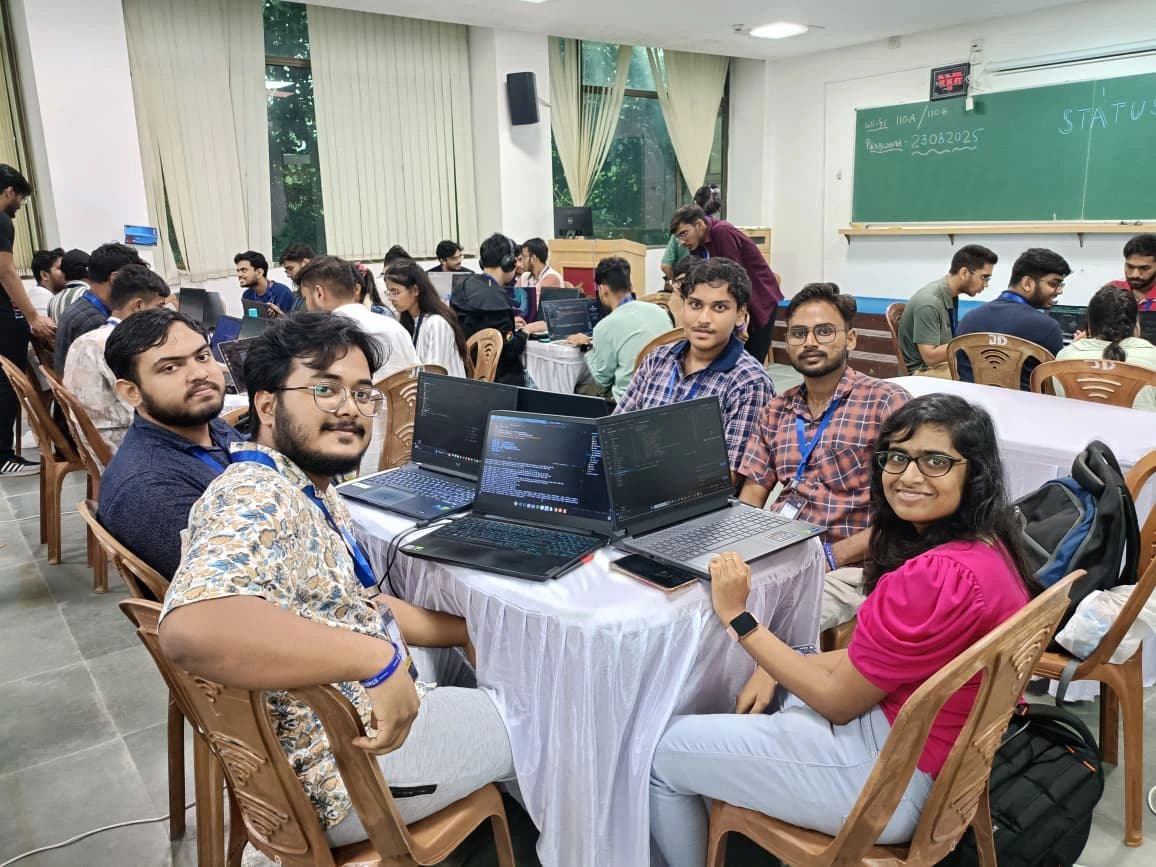 Participants collaborating with laptops around a table