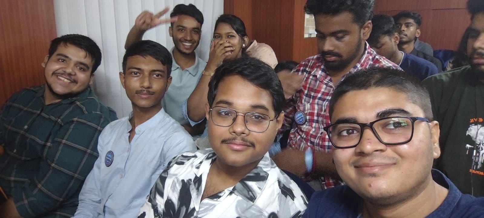 Community members taking a wide classroom selfie