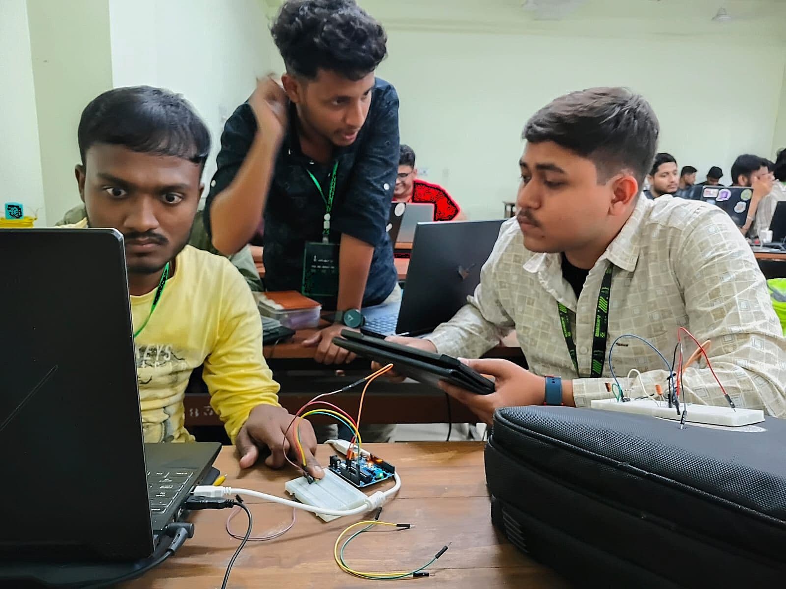 Team members collaborating on an electronics project