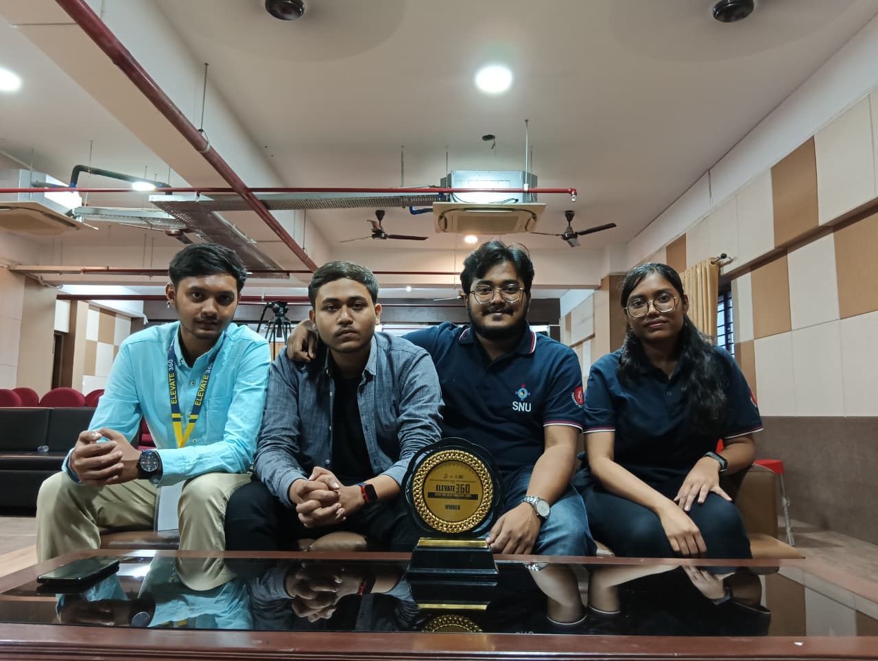 LNC team celebrating an Elevate 360 win with a trophy